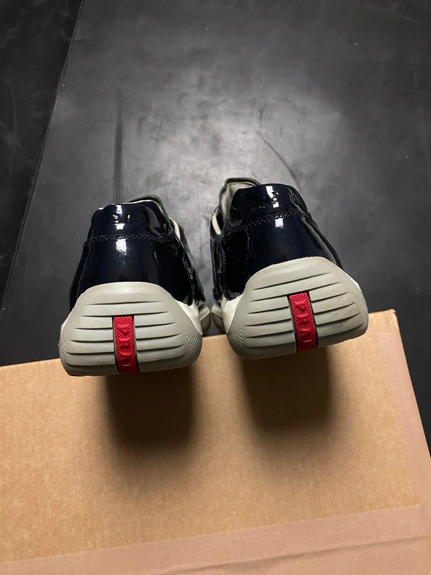 Prada Americas Cup Perforated Patent Trainers